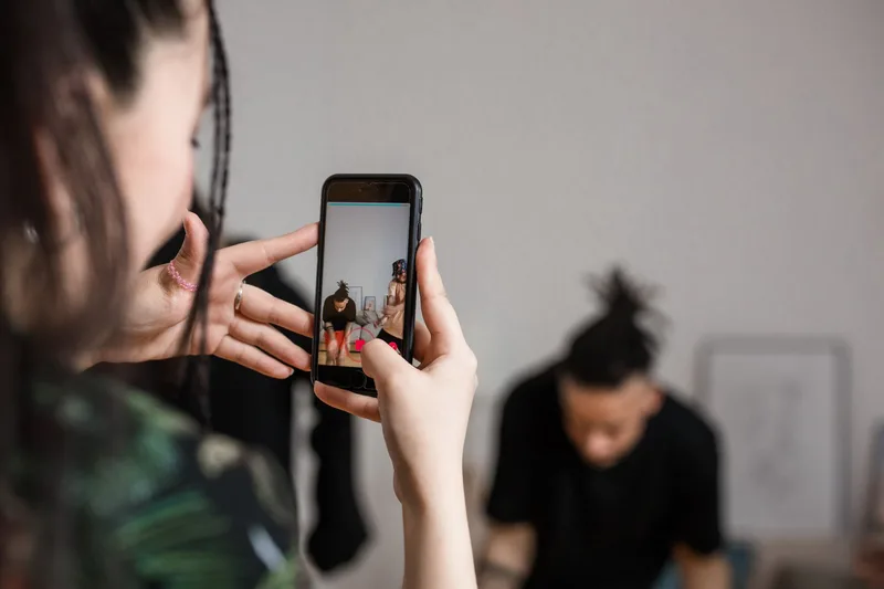 Creator recording a TikTok Duet on a smartphone with a split-screen view
