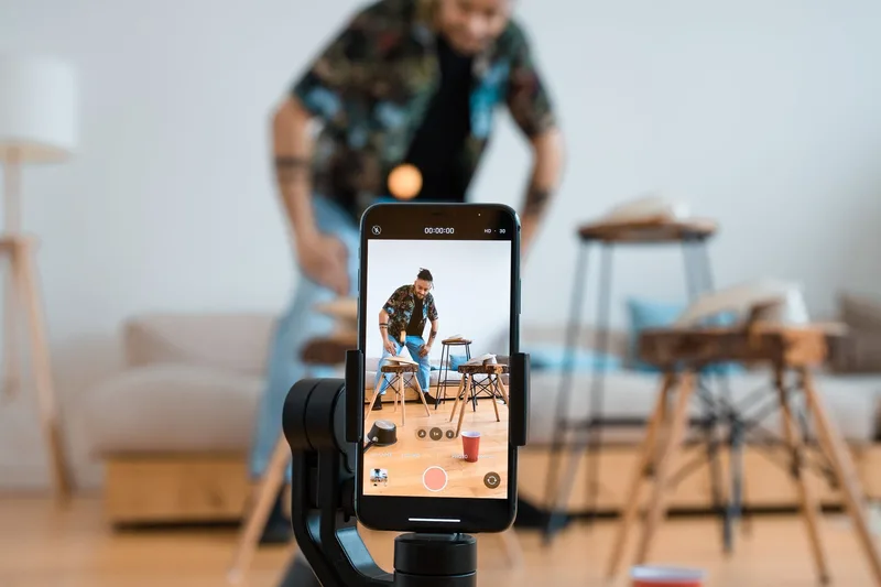 Person using smartphone to browse social media app indoors