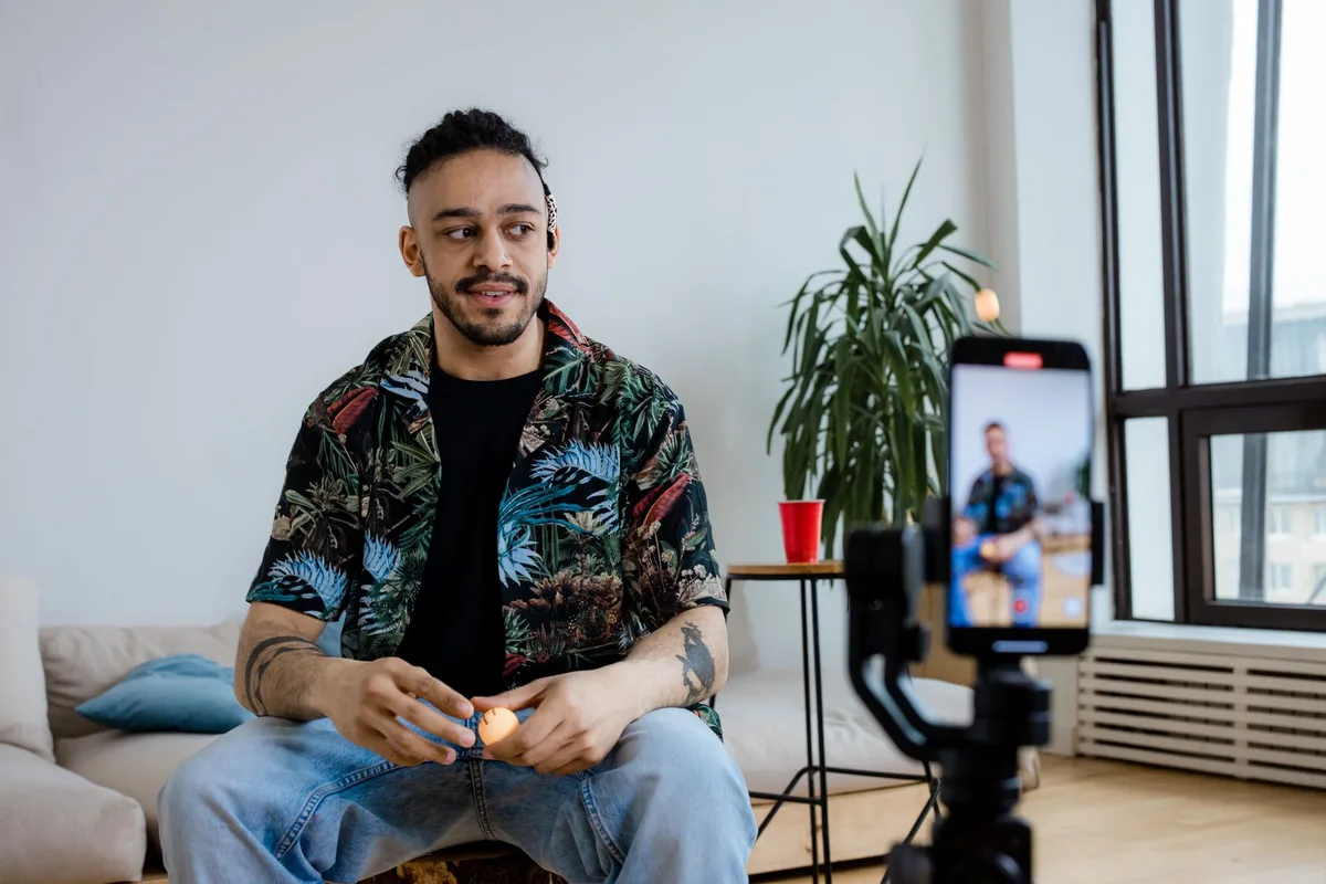 Creator setting up a smartphone on a tripod to record a TikTok video in a well-lit room